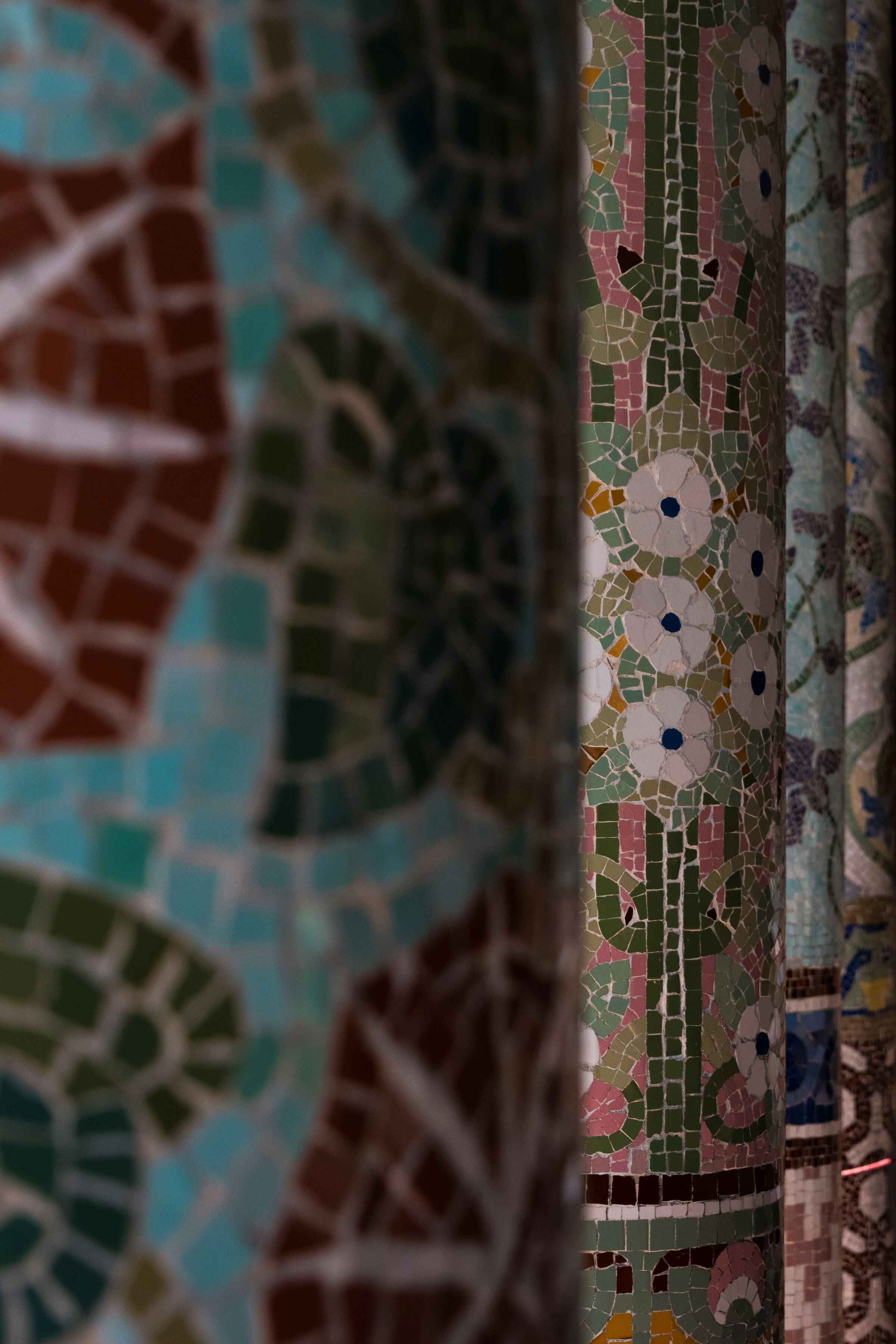 mosaic covered column showcase with floral designs
